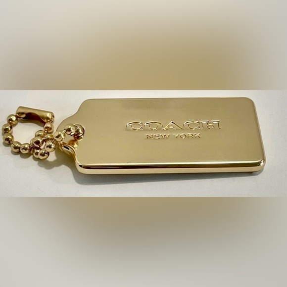 Coach Handbags - Coach Gold tone large metal hang tag. NWOT. Covered with protective plastic.